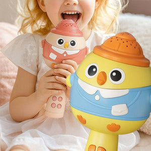 Child playing with colorful kids karaoke microphone and speaker toy designed as cute cartoon characters