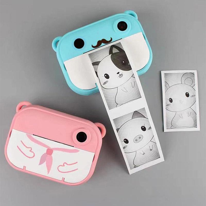 Kid Instant Print Camera in blue and pink printing black and white photo strips with cartoon animals.