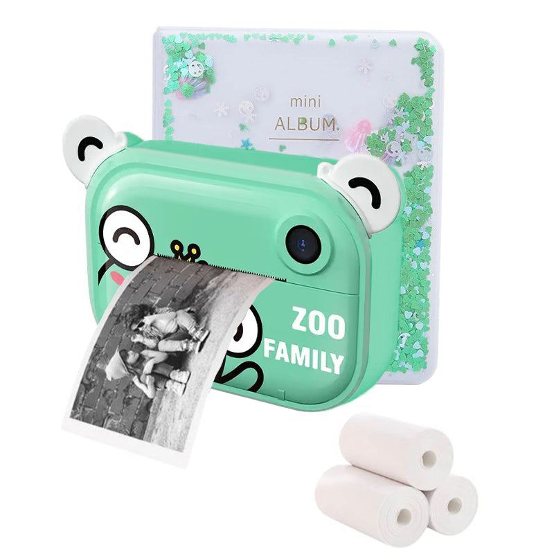 Kid Instant Print Camera in green with cute bear ears printing a black and white photo, mini photo album and thermal paper rolls included